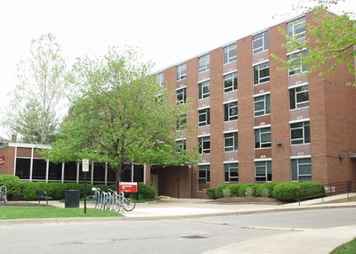Stevenson Hall, a sidewalk with a bicycle rack, and a few trees