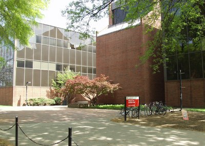 Davidson Hall with a bicycle rack and shade from the trees